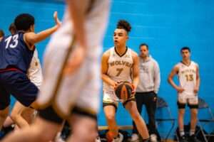 Photograph of basketball players on a basketball court